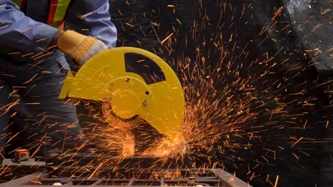 Welder man cutting steel structure with emitting bright orange sparks in factory Stock Footage 135445161