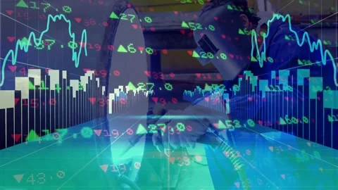 Welder operating torch inside workshop, with floating stock market charts Stock Footage 329697796