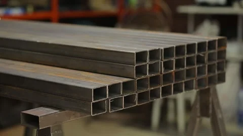  Welder or blacksmith taking metal iron square pipe profiles from warehouse Stock Footage 248714769