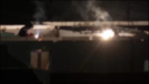 Welder performing arc welding on large metal beam creating brilliant light Stock Footage 329213964