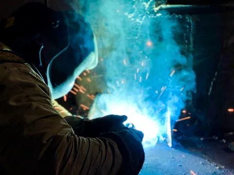 Welder performs welding work on a semi-automatic welding machine Stock Photos