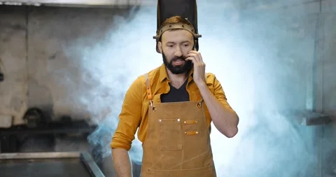 Welder with phone at the workshop Stock Footage 147295602