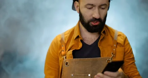 Welder with phone at the workshop 스톡 동영상 147296128