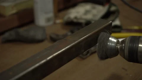 A welder preparing steel by brushing off the rust Stock Footage 202274205