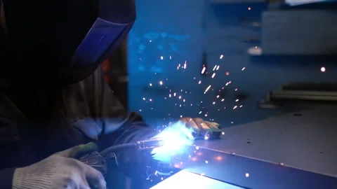 A welder in a protective mask is working with metal, extreme slow motion 240 fps Stock Footage 153660788
