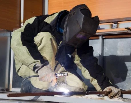 Welder in a special suit while working Stock Photos
