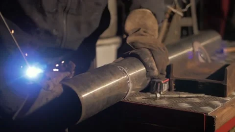 Welder testing shield arc welding electrode flux rod before welding Stock Footage 143699821