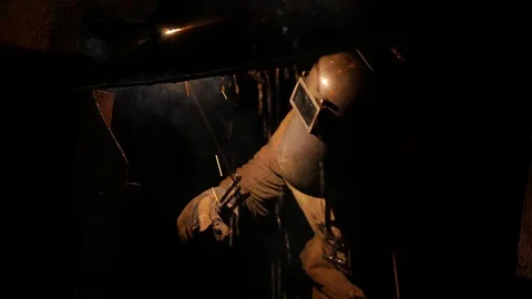 Welder under the ship in dry dock eliminates the hole from which water flows Stock Footage 87298369