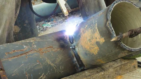 Welder uses arc welding pipe metal on site. Stock Footage 34864711