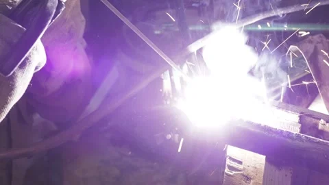 A welder uses an electrode to weld a bicycle frame tube. Stock-Footage 317499217