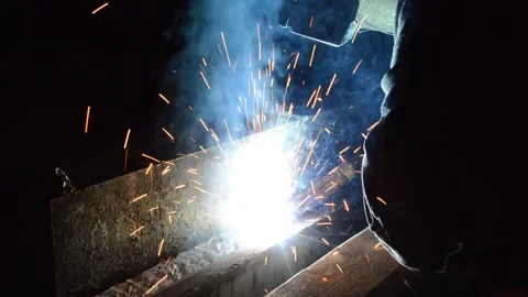 Welder uses torch to make sparks during manufacture of metal equipment Stock Footage 148034797