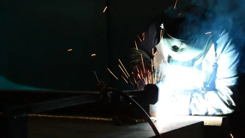 Welder uses torch to make sparks during manufacture of metal equipment Stock Footage 148034935