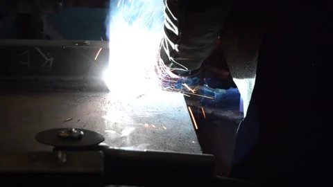 Welder uses torch to make sparks during manufacture of metal equipment Stock Footage 148035124