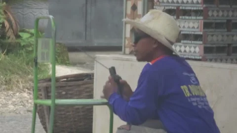 Welder Wearing Straw Hat And Sunglasses Repairing Green Metal Chair Stock Footage 340079220