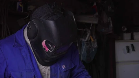 A welder weld metal door in workshop Stock Footage 104263248