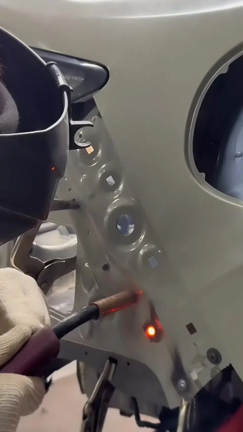 Welder Welding Car Body Panel With Torch and Bright Sparks Stockbeeldmateriaal 348691260