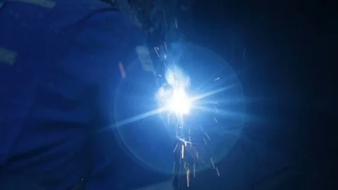 Welder welding large vertical pipes together over shoulder Stock Footage 77278214
