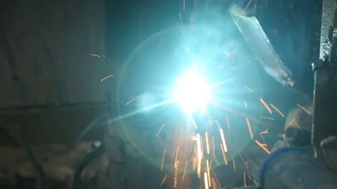 Welder welding large vertical pipes together Stock Footage 77478496