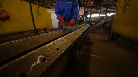 Welder with welding machine in the background of the plant 库存影片 84772337