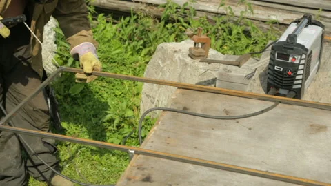 Welder welding metal frame Stock Footage 99902713