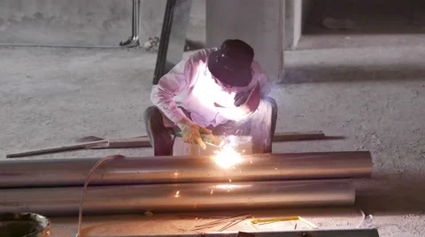 Welder Welding a pipe unsafely using Welding Visor - 4K Stock Footage 51261913