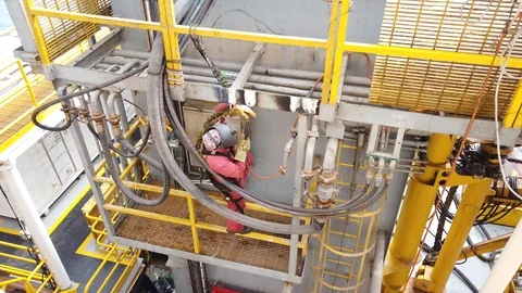Welder welding a rig master skid in a shipyard for repair Stock Footage 102639438