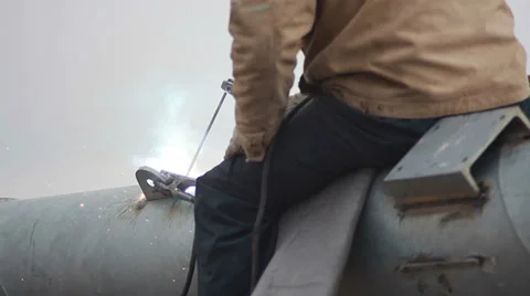 The welder welds fastening on a pipe. Stock Footage 37172319