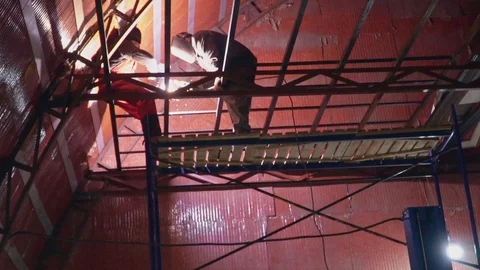 Welder welds a large metal structure in slow motion Stock Footage 104013979