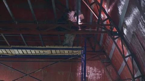 Welder welds a large metal structure in hangar in slow motion Stock Footage 104014174
