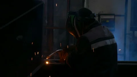 Welder welds large trailer frame at a factory. Stock Footage 197549067