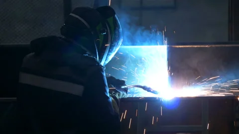 Welder welds large trailer frame at a factory. Stock Footage 197556691