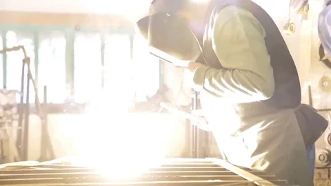 Welder welds metal. Bright arc and spark Stock Footage