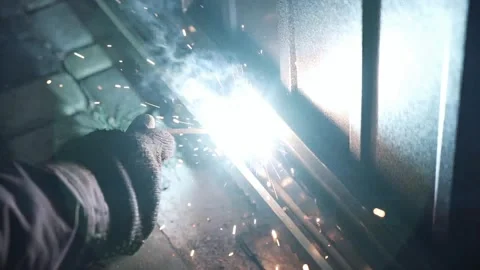 Welder Welds a metal pipe. Iron welding. Welding Sparks Stock Footage 266806387