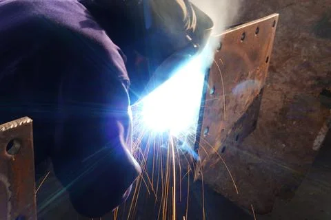 A welder welds metal structures. 스톡 사진