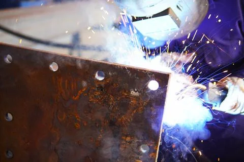 A welder welds metal structures. 스톡 사진