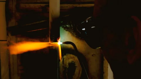 The welder welds the pipe. The man is doing his job Video stock 95683098