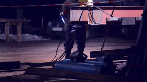 Welder welds structural beams at night Stock Footage 46548572