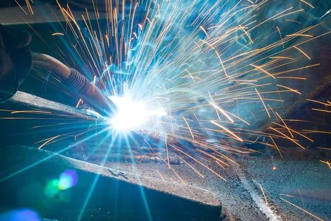 Welder at work close up with sparks. Stock Photos