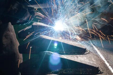 Welder at work close up with sparks. Stock Photos