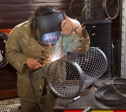 Welder at work, with iron Stock-Fotos
