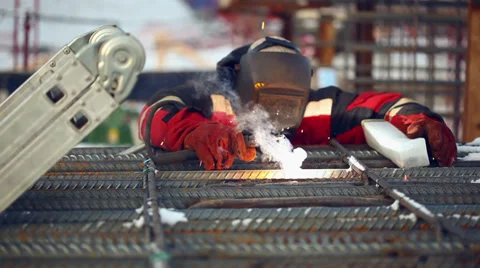 Welder at work, welding a metal framework pile. Stock Footage 36297356