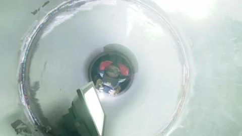 Welder at work while working with a large pipe. Stock Footage 138217201