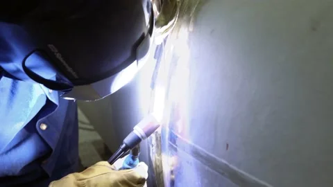 Welder at work while working with a large pipe. Stock Footage 138217869