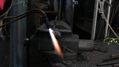 Welder at work. The worker heats the metal part with a gas welder Stock Footage 120112799