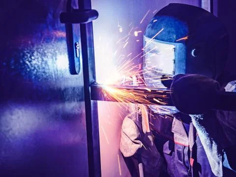Welder Worker Performs Jump Welding. Worker Welder Performs Arc-Welding Process Stock Photos