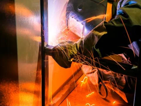 Welder Worker Performs Jump Welding. Worker Welder Performs Arc-Welding Process Stock Photos
