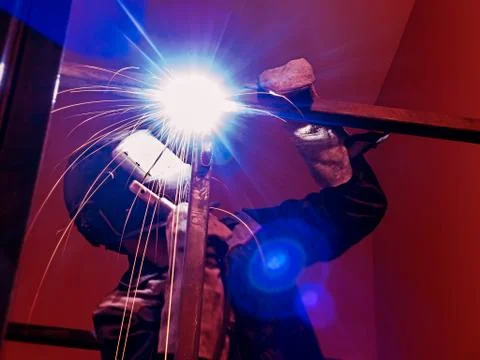 Welder Worker Performs Jump Welding. Worker Welder Performs Arc-Welding Process Stock Photos