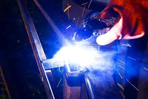 Welder worker performs jump welding. Man welder in protective gloves perfor.. Stock-Fotos