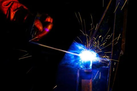 Welder worker performs jump welding. Man welder in protective gloves perfor.. Stock Photos