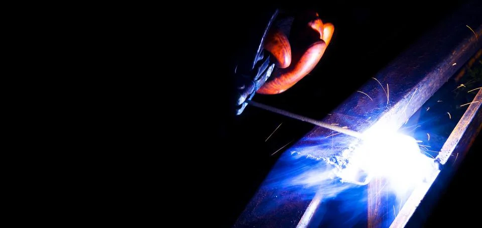 Welder worker performs jump welding. Man welder in protective gloves perfor.. Stock Photos